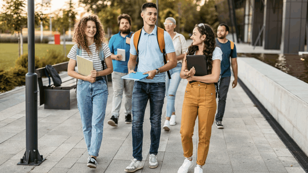 A group of college kids walking with school supplies